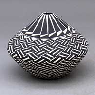 A black-on-white tear-drop jar decorated with a basket weave and geometric design
 by Cletus Victorino of Acoma