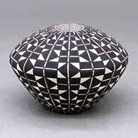 A black-on-white seed pot decorated with a geometric design
 by Cletus Victorino of Acoma