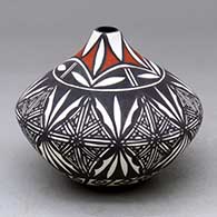 A polychrome tear-drop jar decorated with an eight-panel fine line and geometric design
 by Sandra Victorino of Acoma