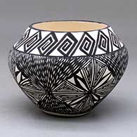 A black-on-white jar decorated with a four-panel fine line and geometric design
 by Sandra Victorino of Acoma