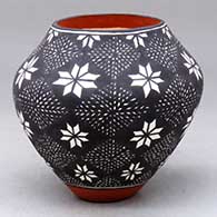 A polychrome jar decorated with a butterfly and fine line geometric design
 by Sandra Victorino of Acoma