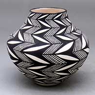 A black-on-white jar decorated with a rock art and geometric design
 by Sandra Victorino of Acoma