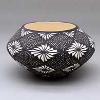 A black-on-white bowl decorated with a fine line and geometric design
 by Sandra Victorino of Acoma