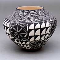 A polychrome jar decorated with a black-on-white fine line and geometric design
 by Sandra Victorino of Acoma