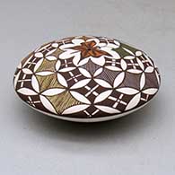 A polychrome seed pot decorated above the shoulder with a butterfly and geometric design, click or tap to see a larger version