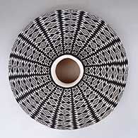 A black-on-white low-shouldered jar decorated with a geometric design
 by Paula Estevan of Acoma