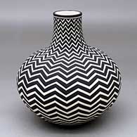 A black-on-white jar with an extended neck and a horizontal lightning bolt design
 by Paula Estevan of Acoma