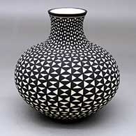 A black-on-white jar with an extended neck and a geometric design
 by Paula Estevan of Acoma