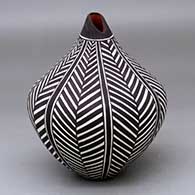 A polychrome tear drop jar decorated with a geometric design
 by Sandra Victorino of Acoma