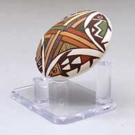 A miniature polychrome seed pot decorated with a four-panel fish and geometric design above the shoulder, click or tap to see a larger version