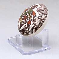 A miniature polychrome seed pot decorated with a turtle, fineline and geometric design above the shoulder, click or tap to see a larger version