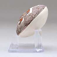 A miniature polychrome seed pot decorated with a turtle, fineline and geometric design above the shoulder, click or tap to see a larger version