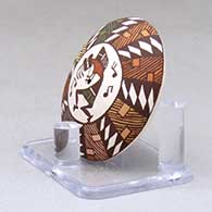 A miniature polychrome seed pot decorated with a kokopelli and geometric design above the shoulder, click or tap to see a larger version