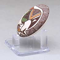 A miniature polychrome seed pot decorated with a cloudeater, fish, fineline and geometric design above the shoulder, click or tap to see a larger version