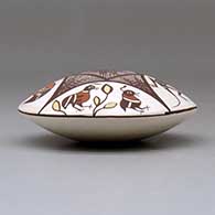 A polychrome seed pot decorated above the shoulder with a bird, rabbit, lizard and fineline geometric design, click or tap to see a larger version