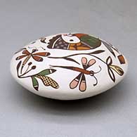 A polychrome seed pot decorated above the shoulder with a hummingbird, dragonfly, flower and geometric design, click or tap to see a larger version