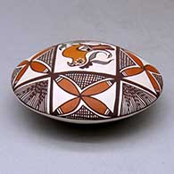 A polychrome seed pot decorated above the shoulder with a parrot, plant, fineline and geometric design, click or tap to see a larger version