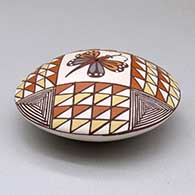 A polychrome seed pot decorated above the shoulder with a butterfly and geometric design, click or tap to see a larger version
