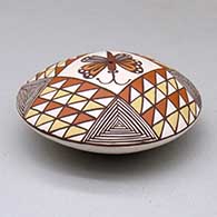 A polychrome seed pot decorated above the shoulder with a butterfly and geometric design, click or tap to see a larger version