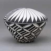 A black on white seed pot decorated with a yucca-leaf snowflake, fineline and geometric design, click or tap to see a larger version