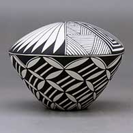 A black on white seed pot decorated with a yucca-leaf snowflake, fineline and geometric design, click or tap to see a larger version