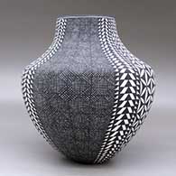 A black on white jar decorated with a four-panel fineline, yucca-leaf snowflake and geometric design, click or tap to see a larger version