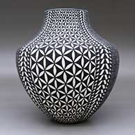 A black on white jar decorated with a four-panel fineline, yucca-leaf snowflake and geometric design, click or tap to see a larger version
