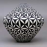 A black on white jar decorated with a yucca-leaf snowflake geometric design, click or tap to see a larger version