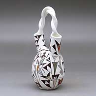A polychrome wedding vase with a twisted handle and decorated with a butterfly, lizard and geometric design, click or tap to see a larger version