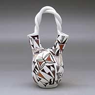 A polychrome wedding vase with a twisted handle and decorated with a butterfly, lizard and geometric design, click or tap to see a larger version