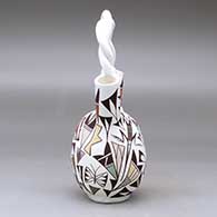 A polychrome wedding vase with a twisted handle and decorated with a butterfly, lizard and geometric design, click or tap to see a larger version