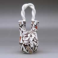 A polychrome wedding vase with a twisted handle and decorated with a kokopelli, bird and geometric design, click or tap to see a larger version