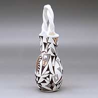 A polychrome wedding vase with a twisted handle and decorated with a butterfly, corn plant, thunderbird and geometric design, click or tap to see a larger version