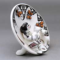 A polychrome self-standing plate decorated with a girl, 2 cats and 3 butterfly appliques, all painted appropriately, plus a could formation and geometric design, click or tap to see a larger version