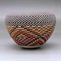 A polychrome jar with an Infinity rim and decorated with a stylized checkerboard and stripe geometric design, click or tap to see a larger version