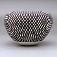 A black on white jar with an Infinity rim and decorated with a checkerboard geometric design, click or tap to see a larger version