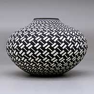 A black on white jar decorated with a basket weave geometric design, click or tap to see a larger version