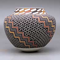 A polychrome jar with a raised rim and decorated with a tiny square and geometric design, click or tap to see a larger version