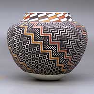 A polychrome jar with a raised rim and decorated with a tiny square and geometric design, click or tap to see a larger version