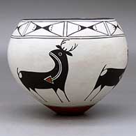 A polychrome bowl decorated around the body with a four-panel deer-with-heart-line design and with a butterfly geometric design around the opening, click or tap to see a larger version