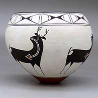 A polychrome bowl decorated around the body with a four-panel deer-with-heart-line design and with a butterfly geometric design around the opening, click or tap to see a larger version