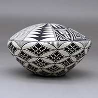 A black on white seed pot decorated with a yucca-leaf snowflake, fineline and geometric design, click or tap to see a larger version