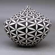 A black on white tear drop jar decorated with a yucca-leaf snowflake and geometric design, click or tap to see a larger version