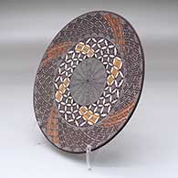 A polychrome plate decorated with a North Star fineline and geometric design, click or tap to see a larger version