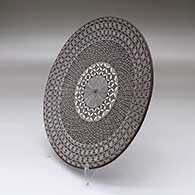 A black on white plate decorated with a North Star fineline and geometric design, click or tap to see a larger version