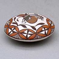 A miniature polychrome seed pot decorated with a parrot, branch, fineline and geometric design above the shoulder, click or tap to see a larger version