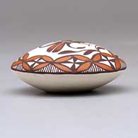 A miniature polychrome seed pot decorated with a parrot, branch, fineline and geometric design above the shoulder, click or tap to see a larger version
