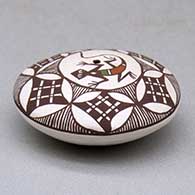 A miniature polychrome seed pot decorated with a lizard, fineline and geometric design above the shoulder, click or tap to see a larger version