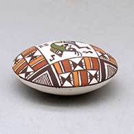 A miniature polychrome seed pot decorated with a kokopelli and geometric design above the shoulder, click or tap to see a larger version