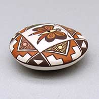 A miniature polychrome seed pot decorated with a butterfly, fineline and geometric design above the shoulder, click or tap to see a larger version